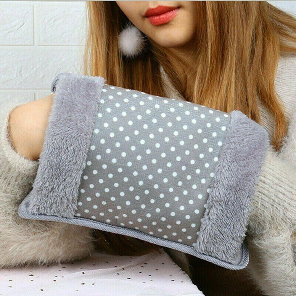 Person holding a gray polka dot pillow with fluffy edges
