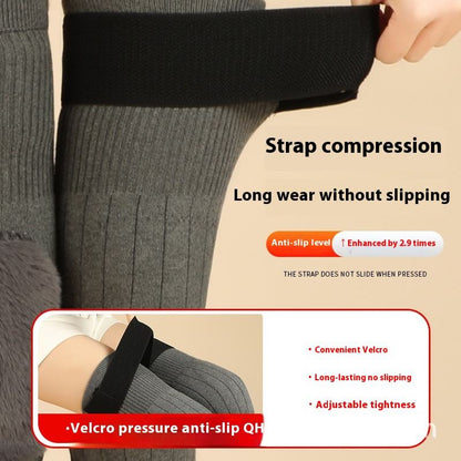 Gray compression stocking with strap compression feature on a beige background